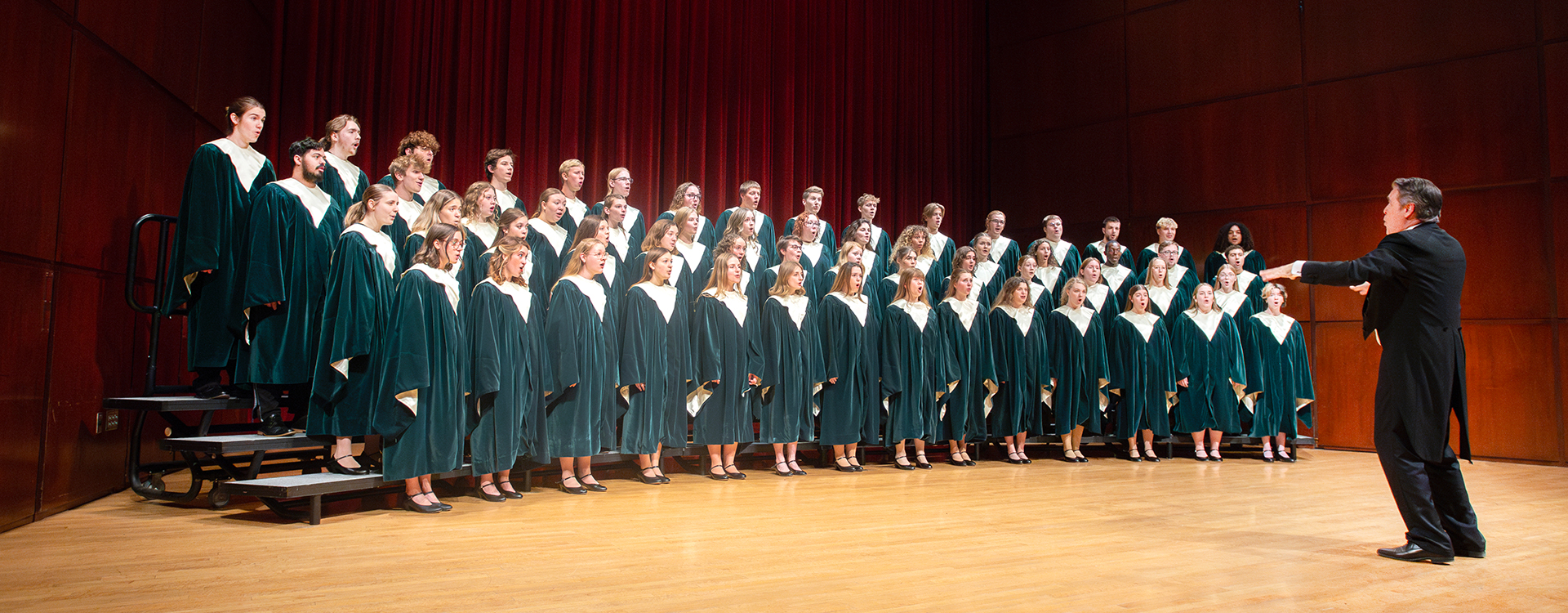 WLC students on concert hall stage for choir rehearsal